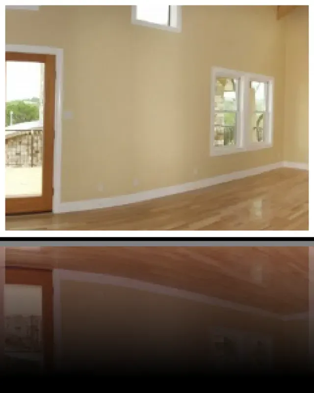 An empty room with hardwood floors and a sliding glass door