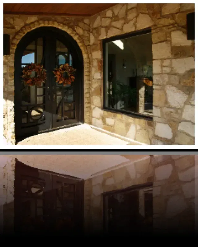 A stone building with a black door and a window