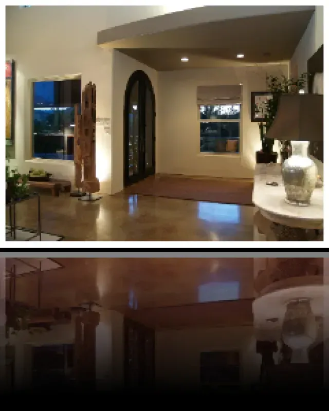 A living room with a lamp and a vase on a table