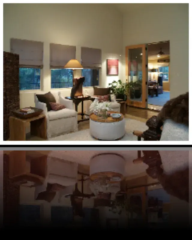 A living room with white furniture and a round coffee table