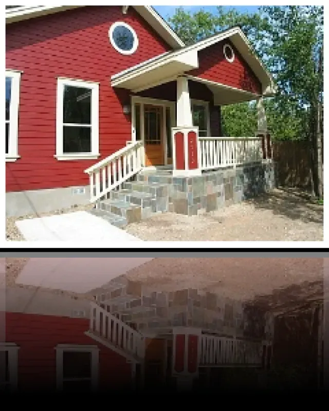 A red house with a white porch and stairs