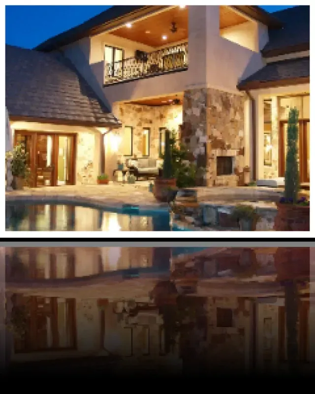 A large house with a swimming pool in front of it