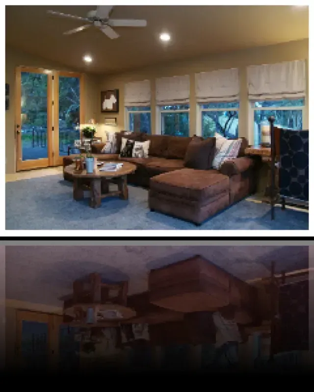 A living room with a couch and a ceiling fan