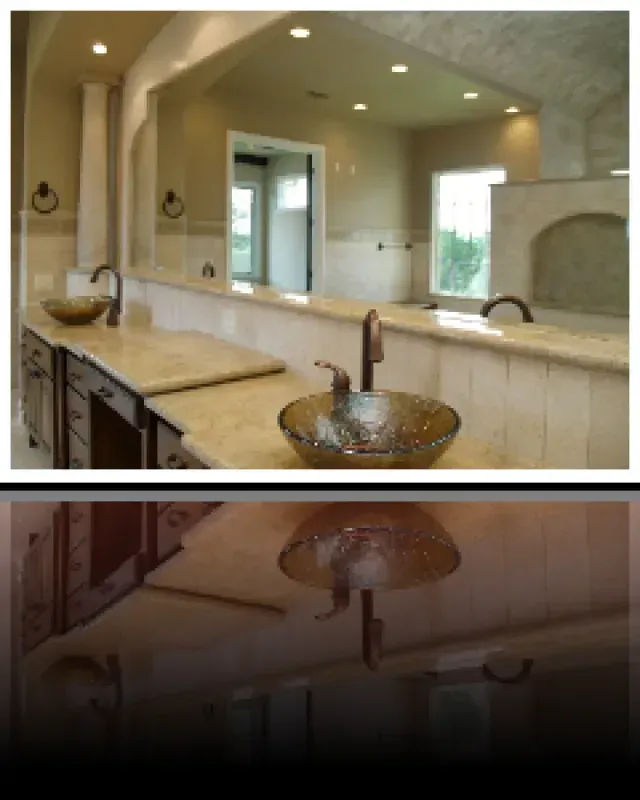 A bathroom with a sink and a large mirror