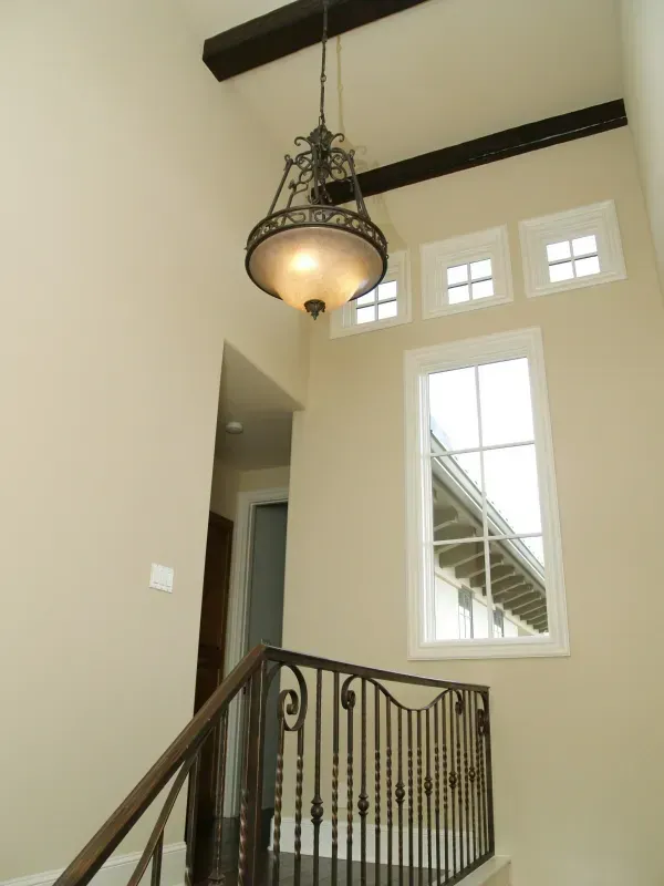 A staircase with a chandelier hanging from the ceiling