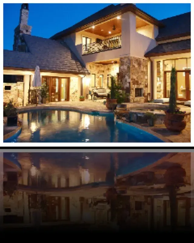 A house with a large swimming pool in front of it