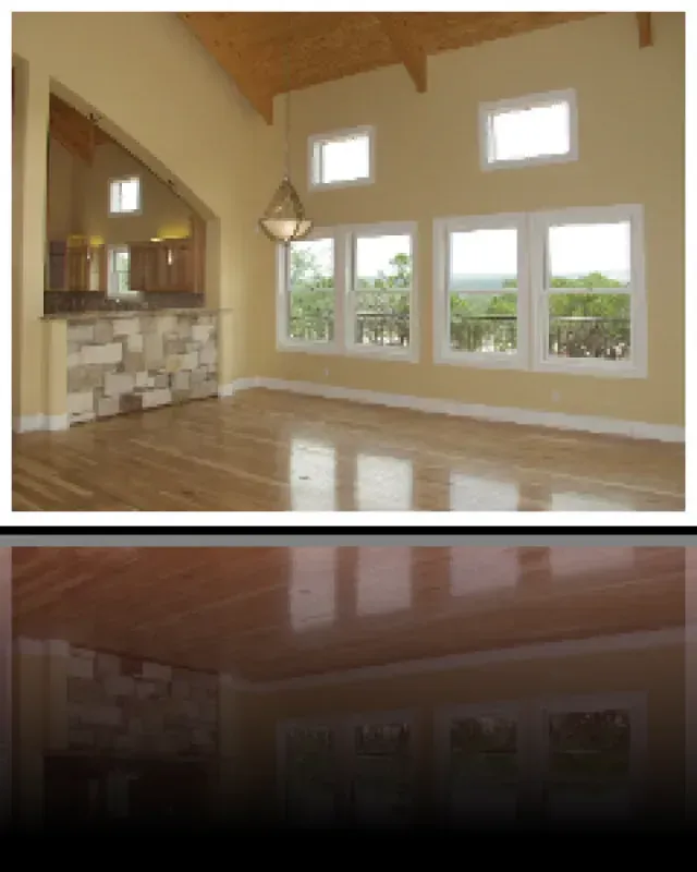 An empty room with lots of windows and a wooden floor