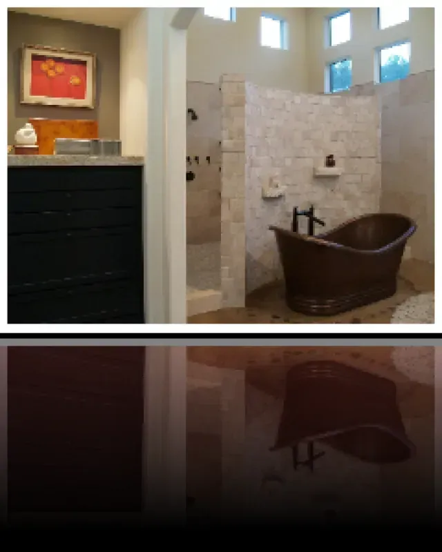 A bathroom with a bathtub and a picture on the wall