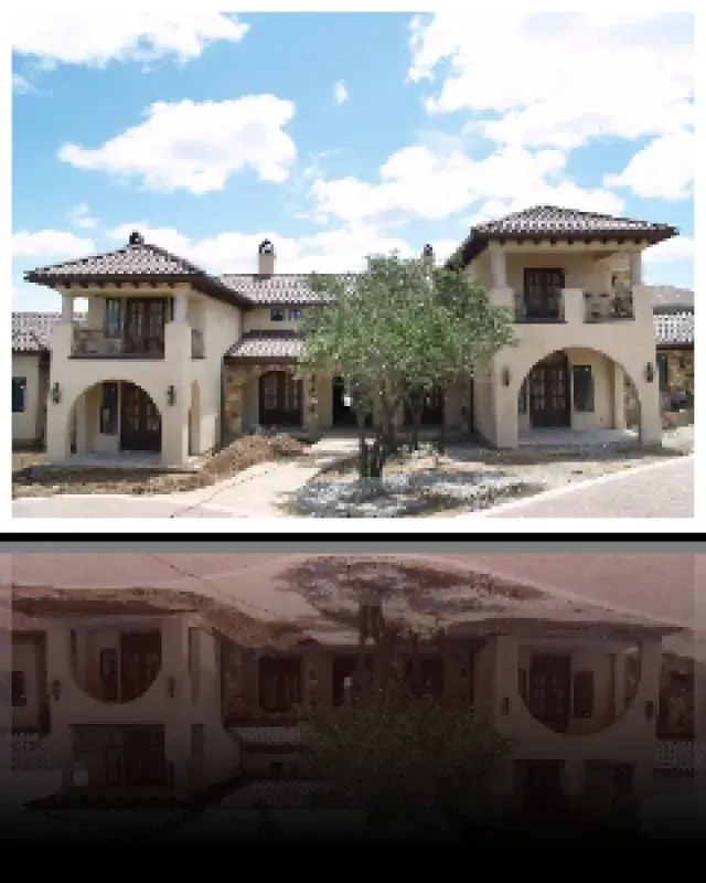 A picture of a house with a tree in front of it