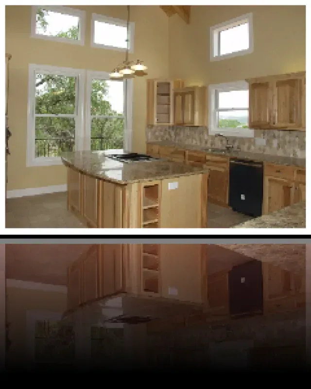 A kitchen with a large island and lots of windows