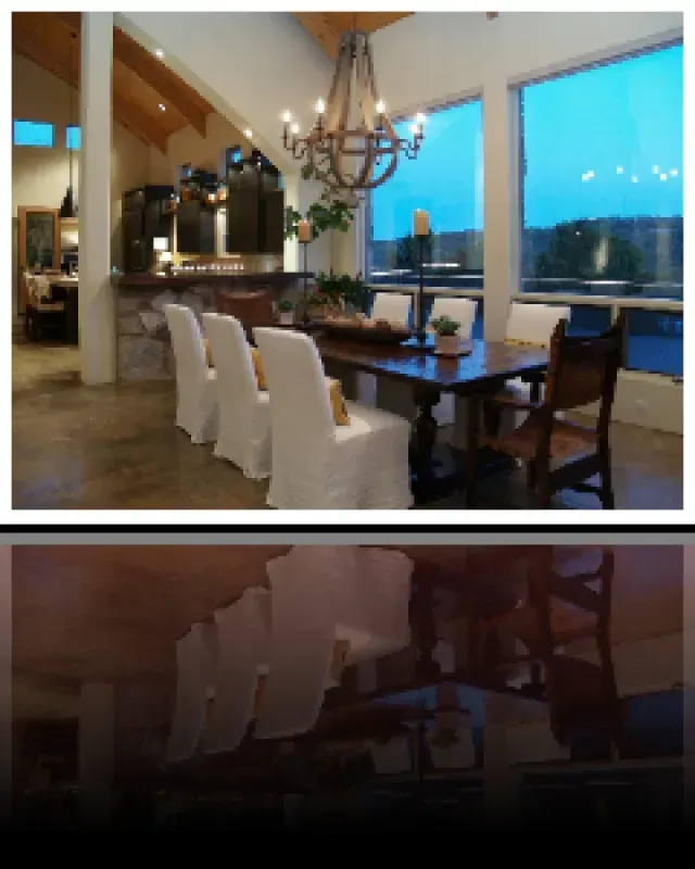 A dining room with a table and chairs and a chandelier