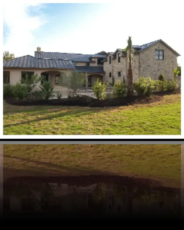 A large house sits in the middle of a lush green field