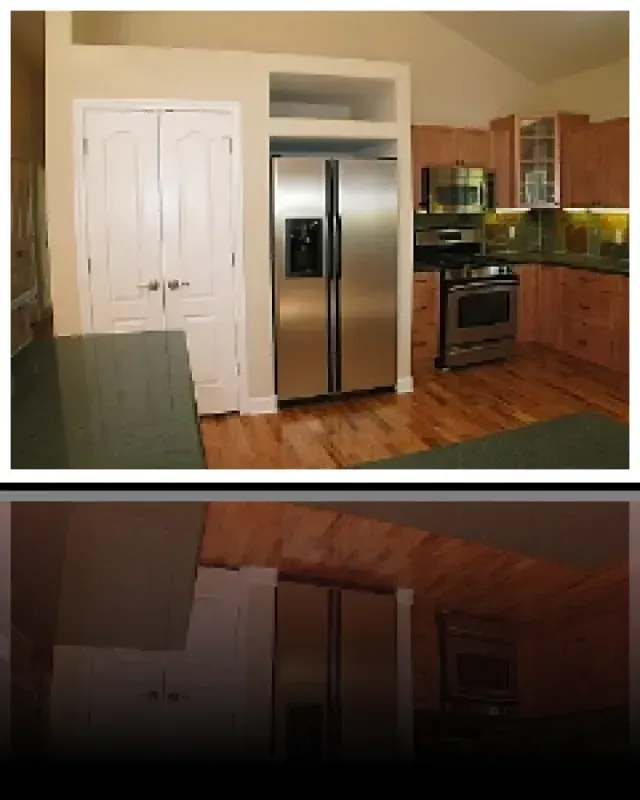 A kitchen with a stainless steel refrigerator and stove