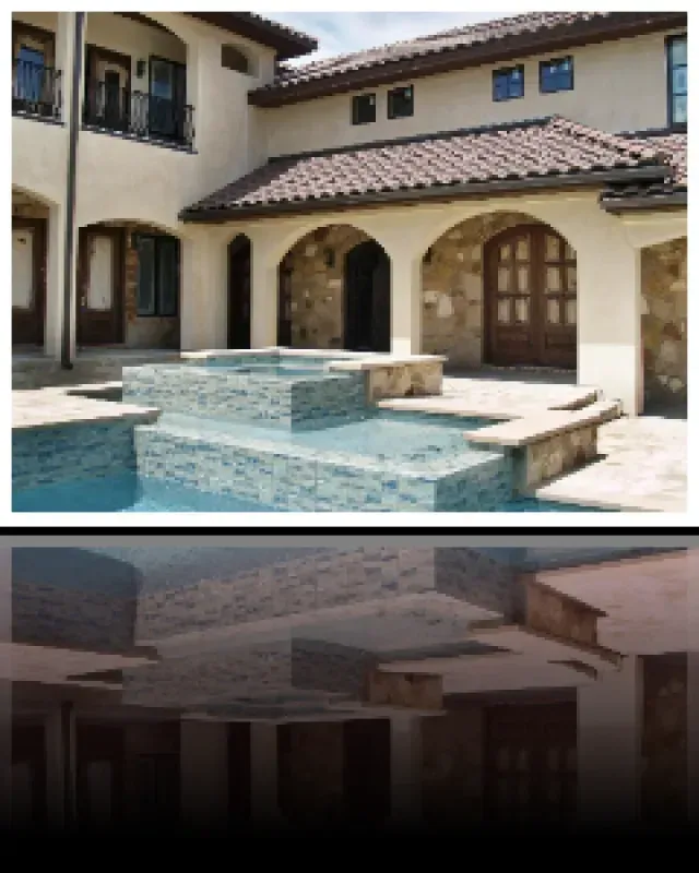 A large house with a swimming pool in front of it