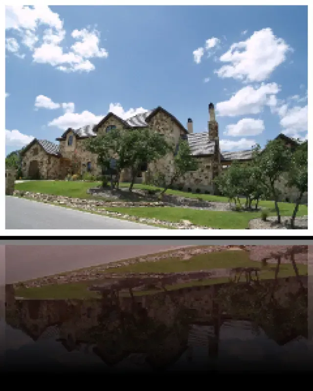 A picture of a large house with trees in front of it