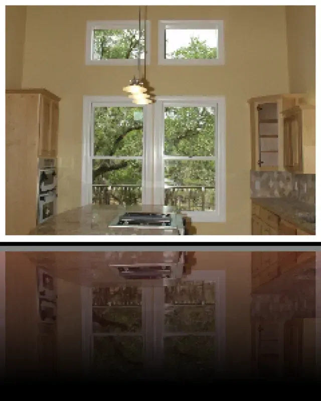 A kitchen with lots of windows and a stove top oven