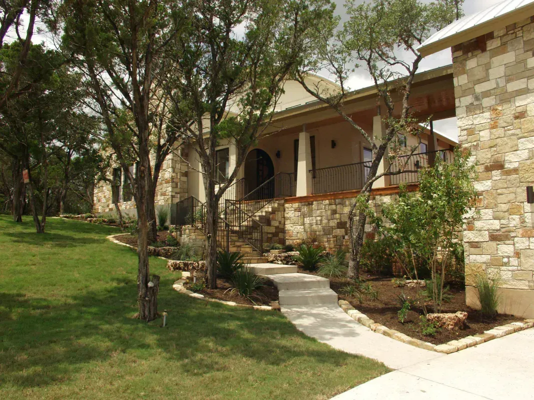 A large stone house with a walkway leading to it