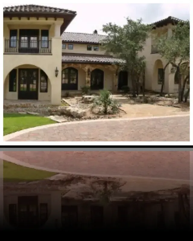A picture of a house with a reflection of the house in the water