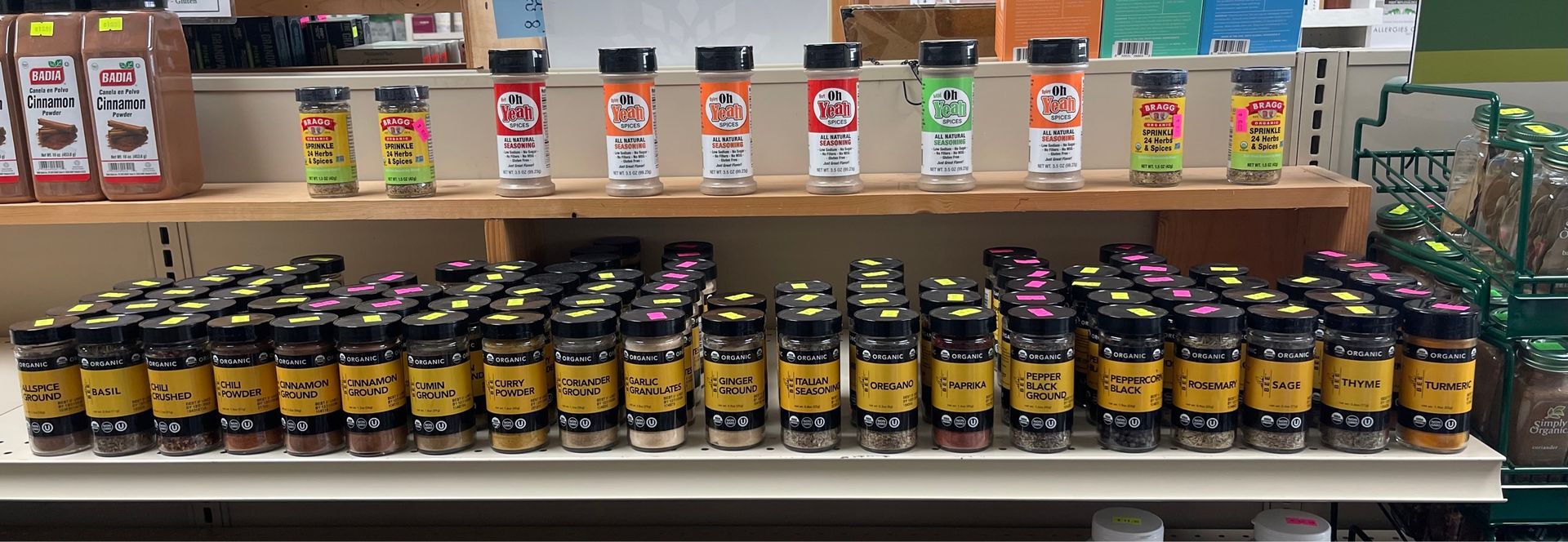 A shelf filled with jars of spices in a store.