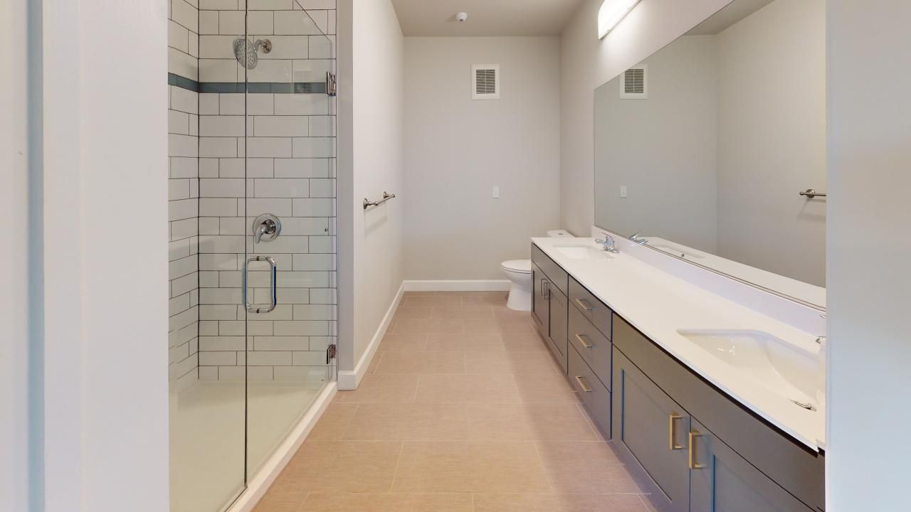 A bathroom with a walk in shower , sink , and mirror.
