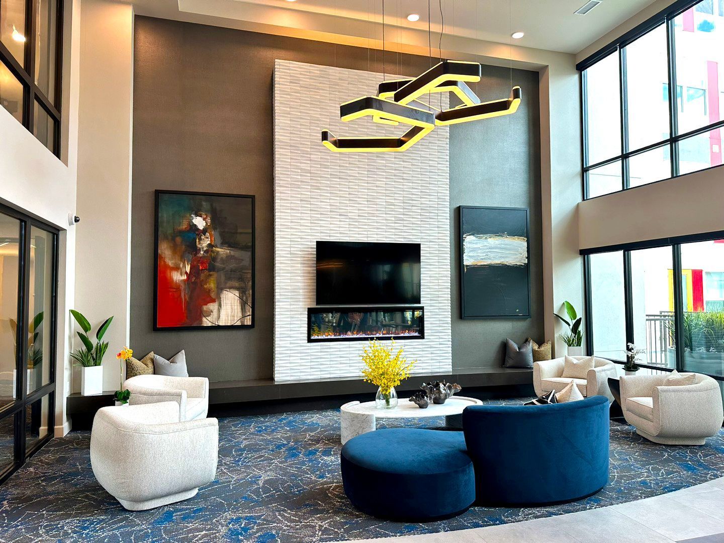 Clubhouse filled with furniture and a flat screen tv.