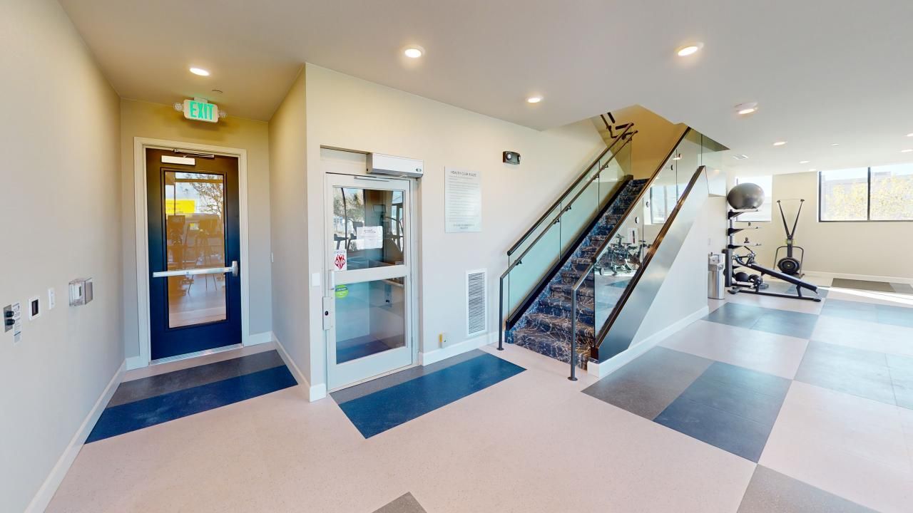 A hallway with stairs leading up to the second floor of a building.