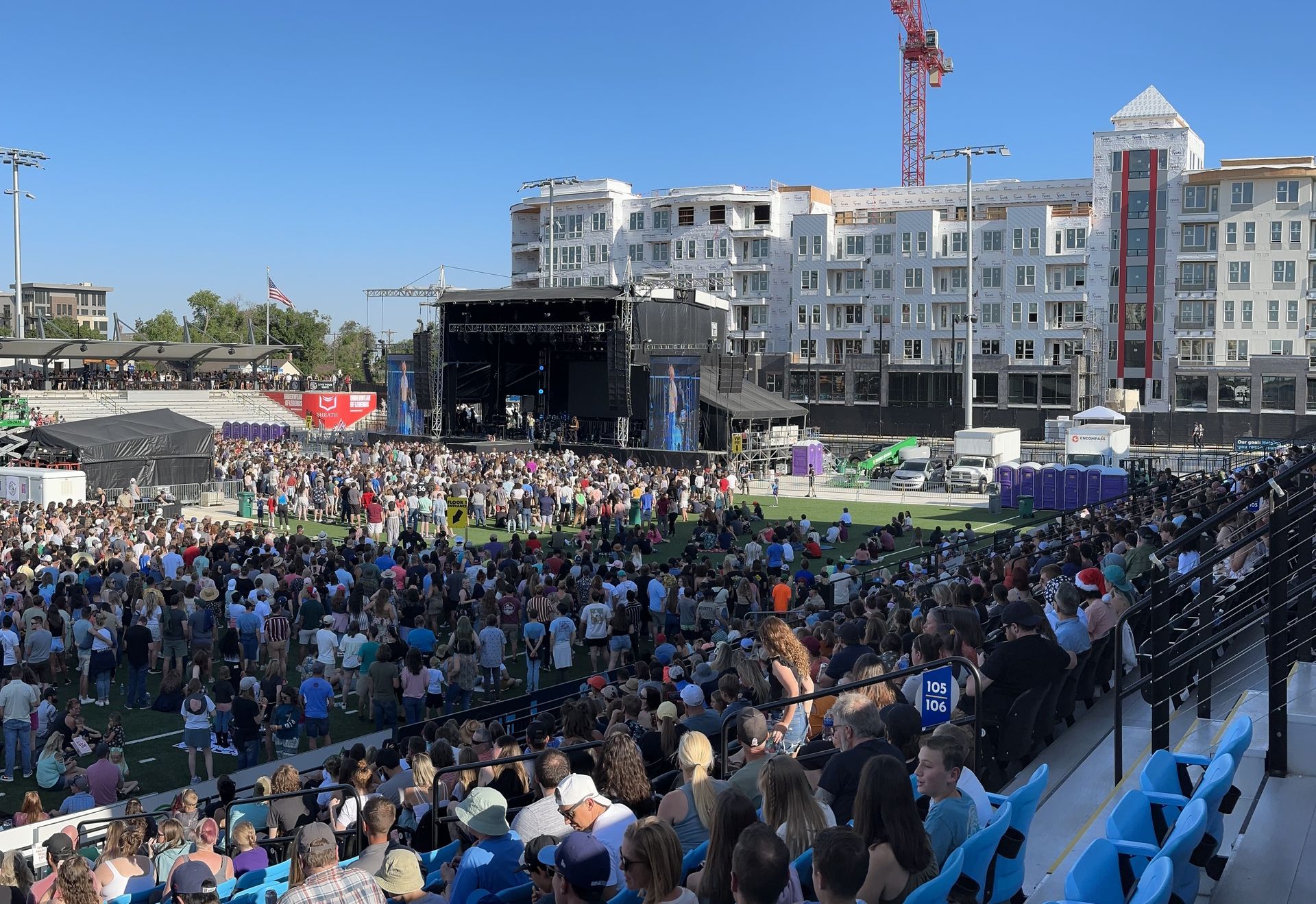 A large crowd of people are sitting in front of a stage at a concert at The Experience at Epicenter