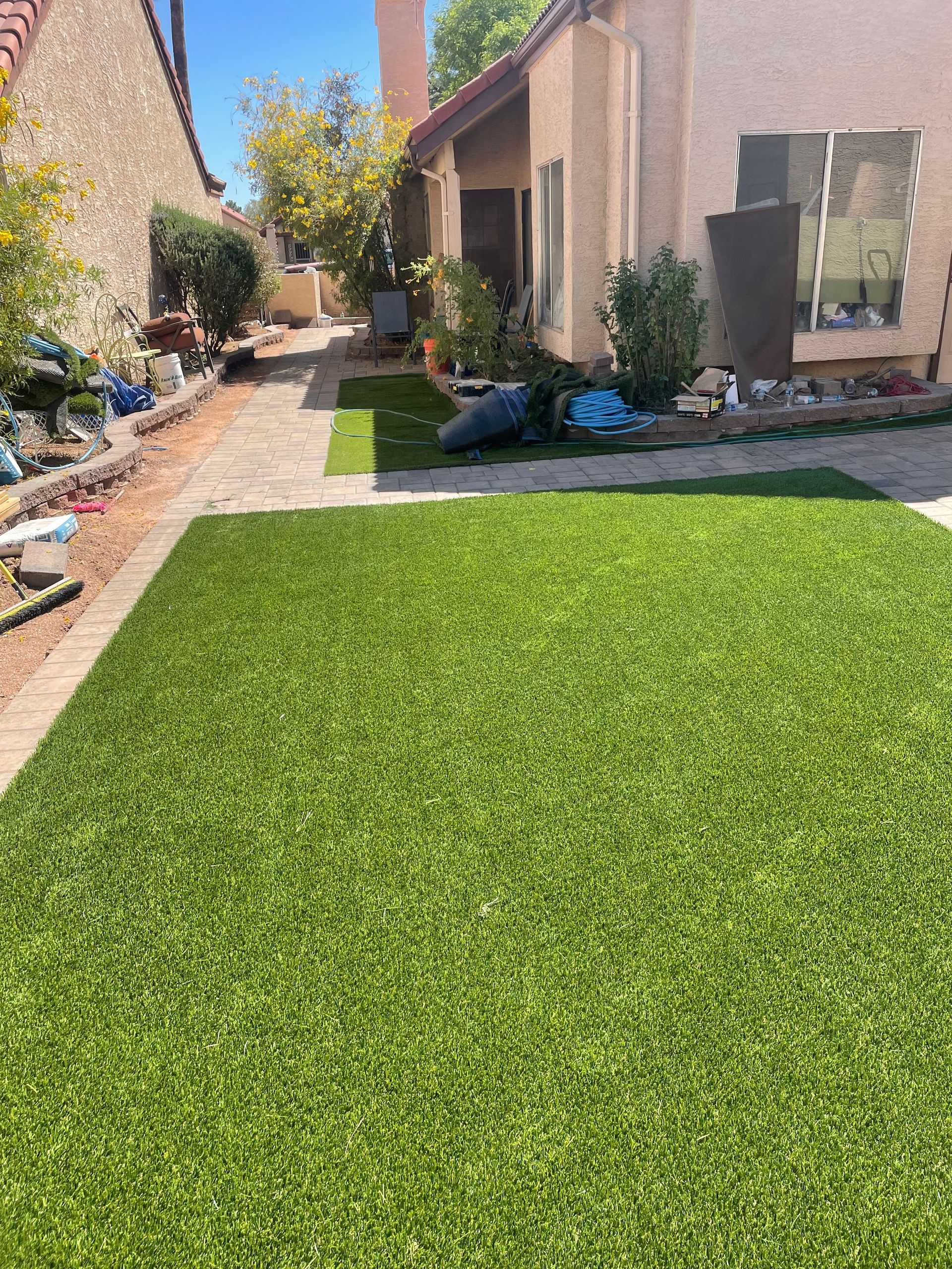 A lush green lawn in front of a house.