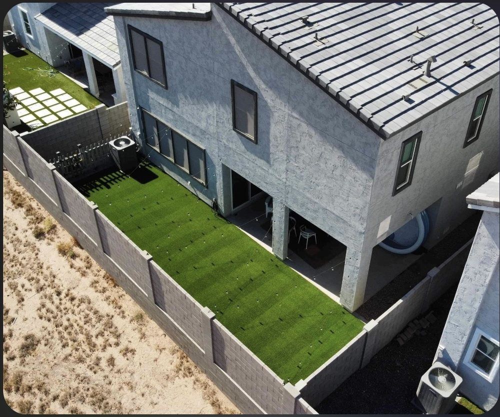 An aerial view of a house with a fence around it