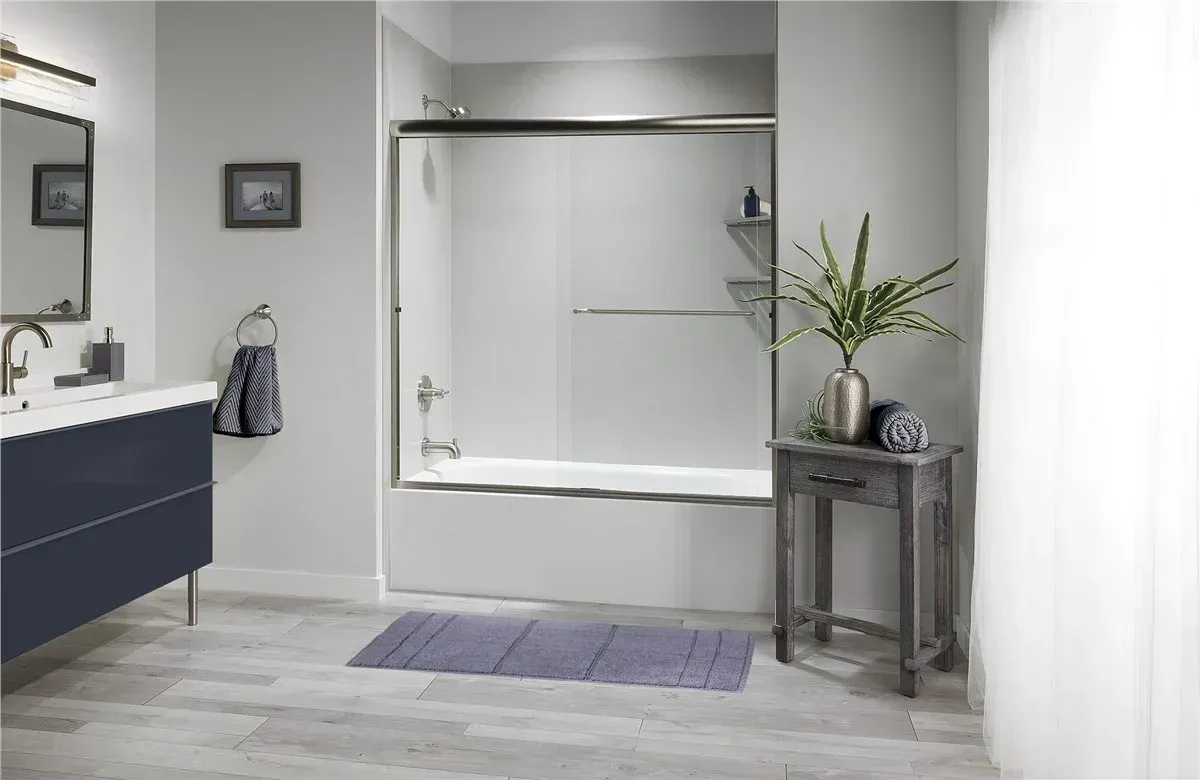 Contemporary bathroom featuring a white quartz countertop vanity with dark navy cabinetry, chrome