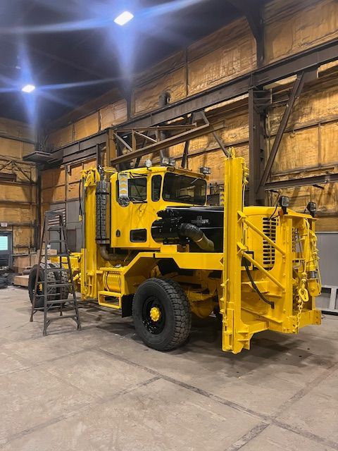 Yellow industrial truck in a workshop.