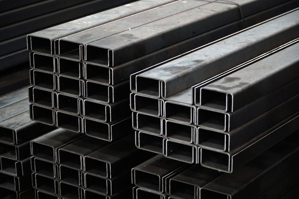 Warehouse interior with steel beams and a forklift.