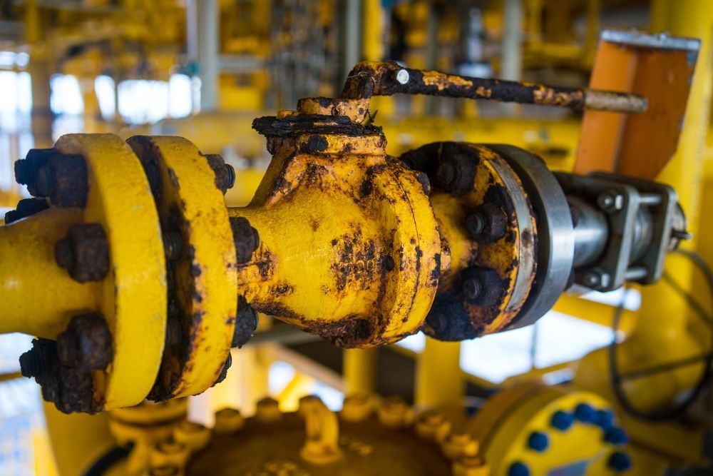 Warehouse interior with steel beams and a forklift.