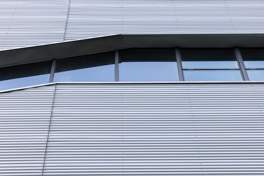 Warehouse interior with steel beams and a forklift.