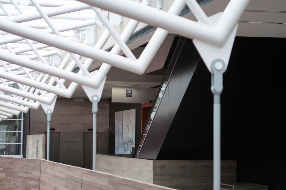 Warehouse interior with steel beams and a forklift.