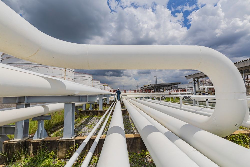 Warehouse interior with steel beams and a forklift.
