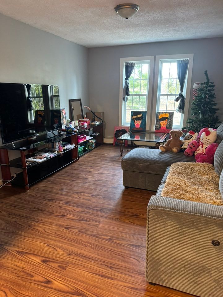 A living room filled with furniture and a christmas tree.