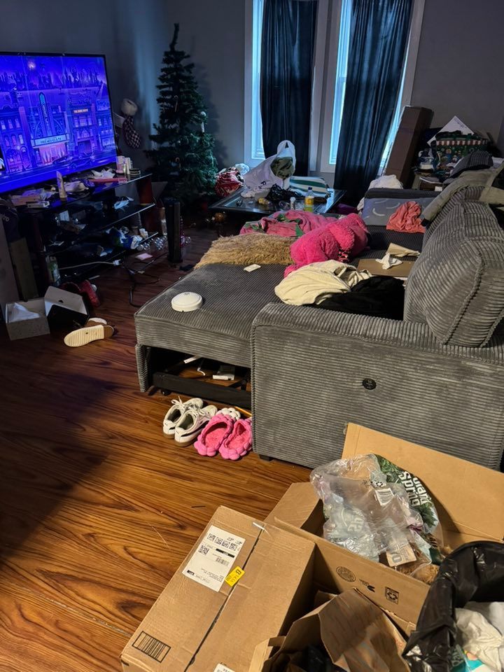 A living room filled with lots of boxes and a couch.