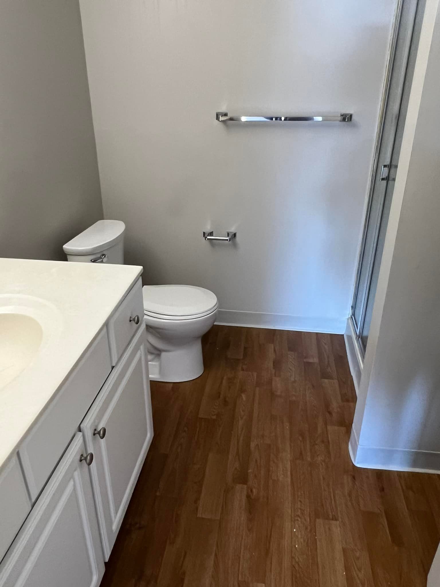 A bathroom with a toilet , sink , and shower.