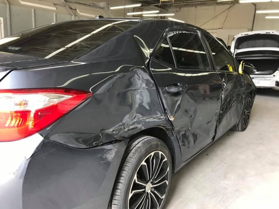 The inside of a moving truck filled with boxes and blankets.