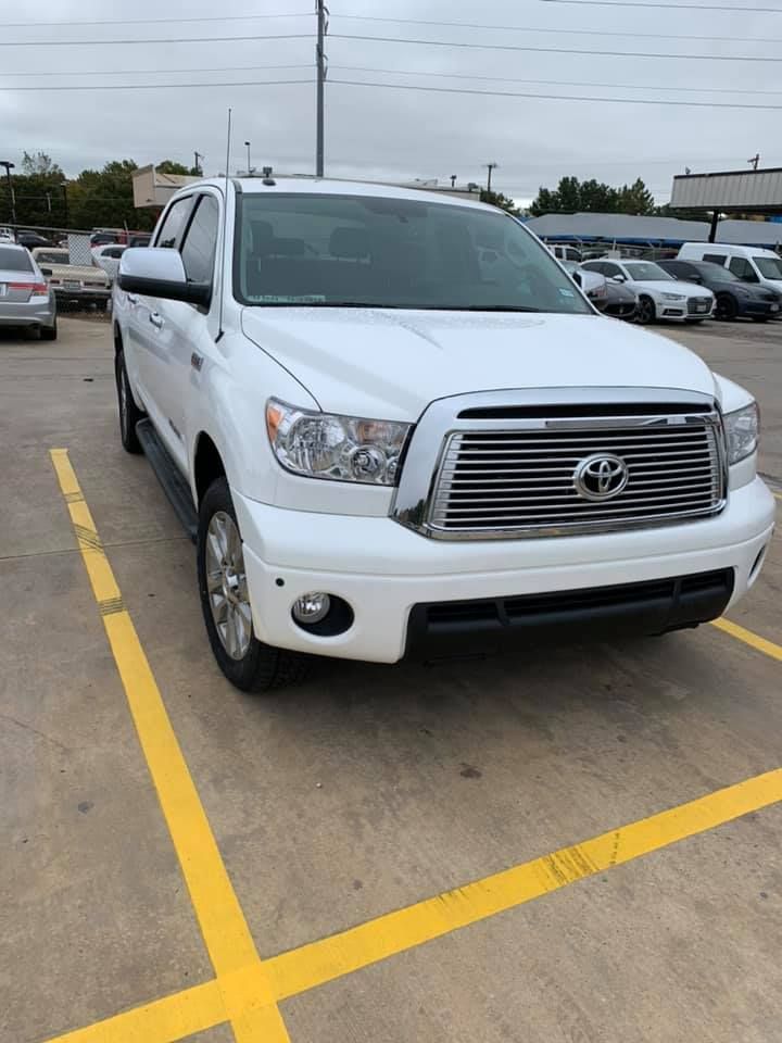 White Toyota Tundra truck parked in a parking lot.