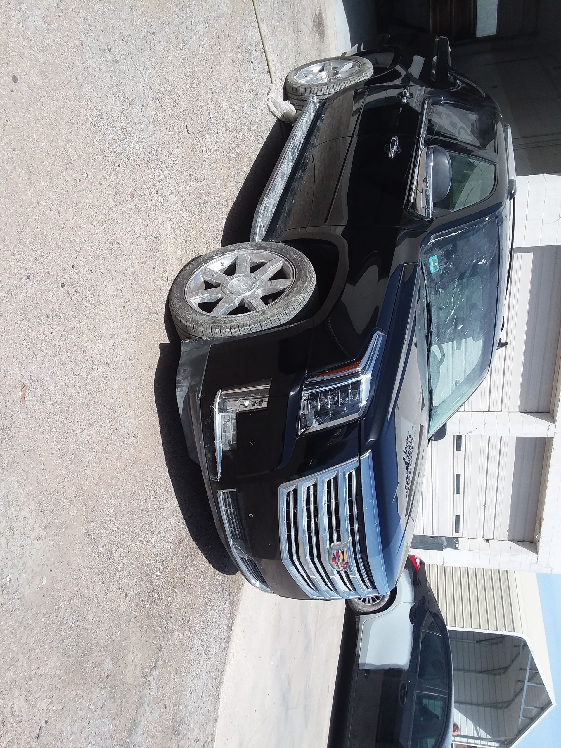 Black SUV parked outdoors on a sunny day.