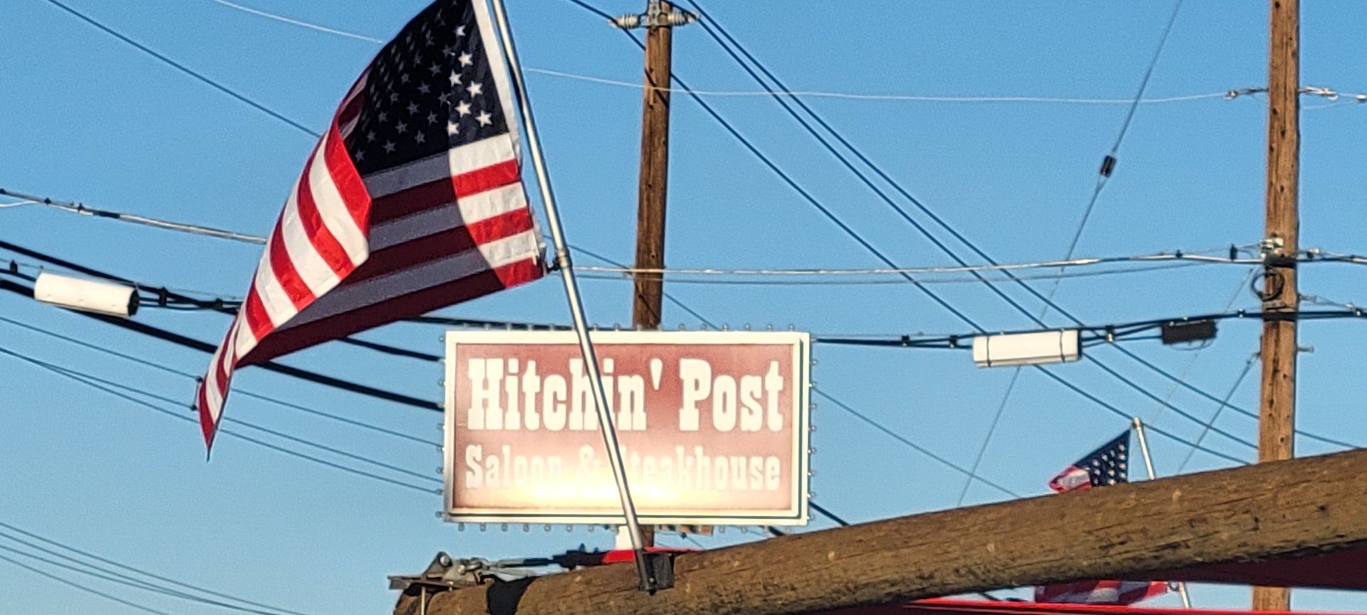 American flag waving in front of the Kitchin' Post