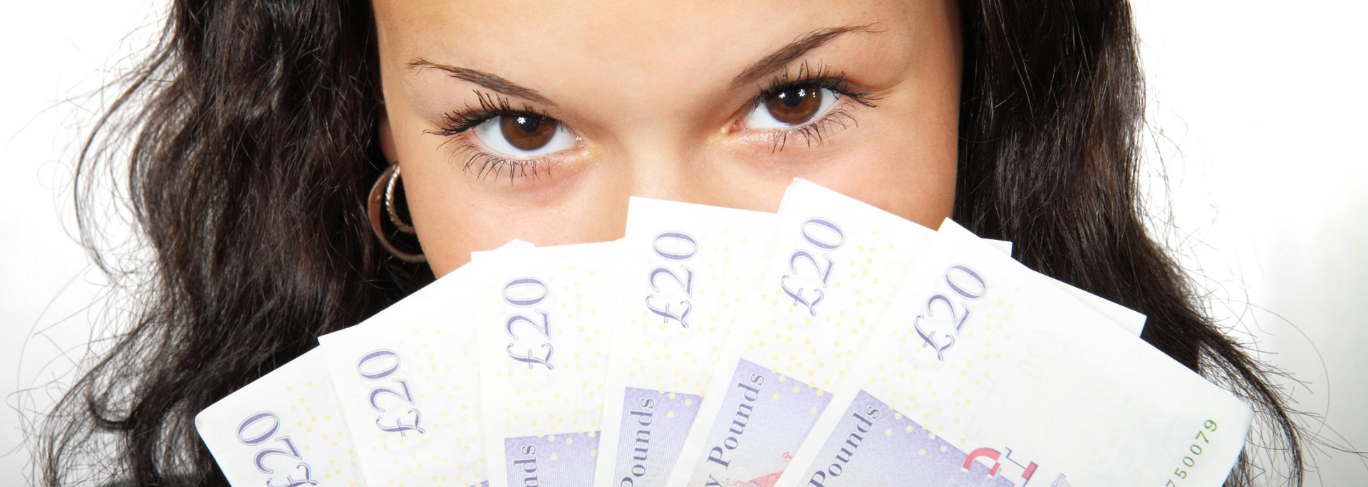 Picture of a person holding money over their face. 