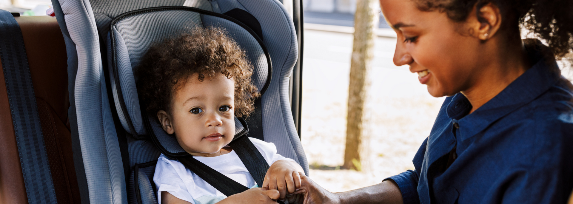 Picture of a child in a child seat in a car.