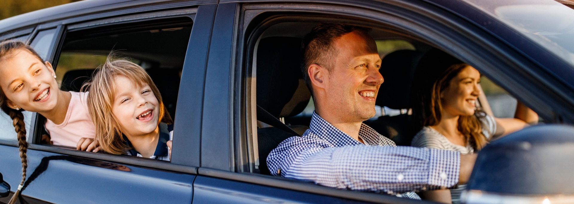 Picture of a family having fun in a car. 