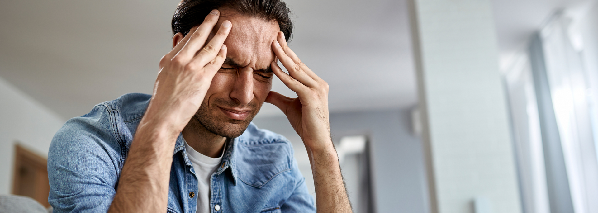 Picture of a person holding their head as if they have a headache. Picture of a person holding their head as if they have a headache.