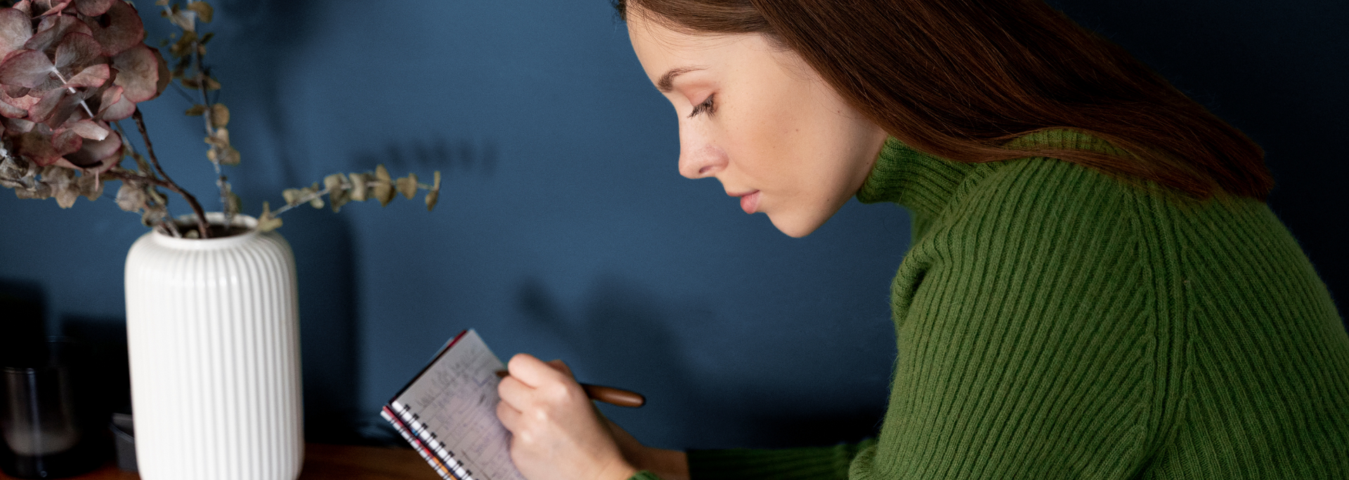Picture of a person writing a list on a notepad. Picture of a person writing a list on a notepad.