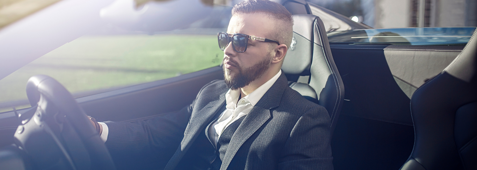 Picture of a businessperson in a swish-looking car.