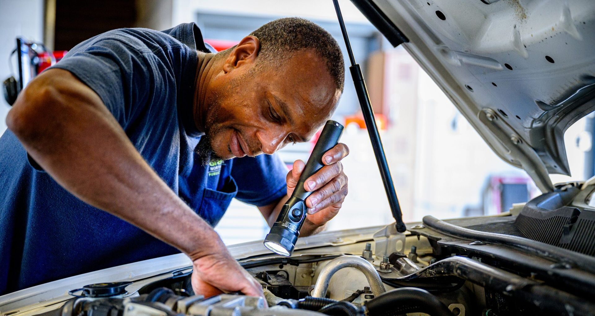 Picture of someone inspecting a car